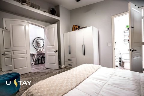 Bright modern bedroom with en suite bath and extra storage