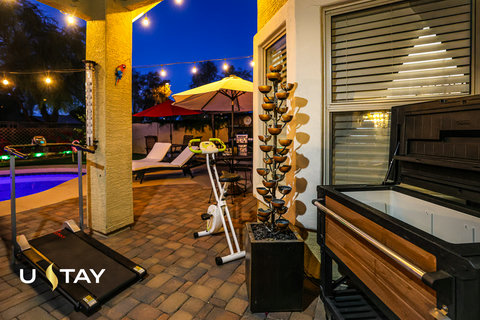 Resort-style patio with pool views, lounge seating, and wellness amenities