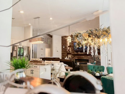 Stylish open-concept living with chandelier lighting and a cozy fireplace