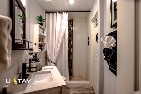 Bright, stylish bathroom with modern vanity and walk-in shower