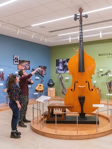 Unique music museum exhibit with oversized bass and interactive displays