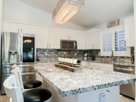 Bright modern kitchen with oversized granite island and stylish finishes