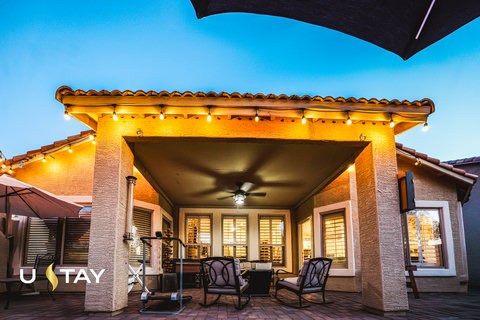 Cozy covered patio with string lights and stylish outdoor seating