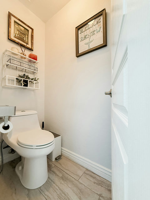 Bright, stylish powder room with modern finishes and charming decor