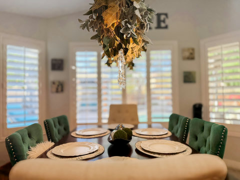 Elegant sunlit dining room with seating for six and stylish decor