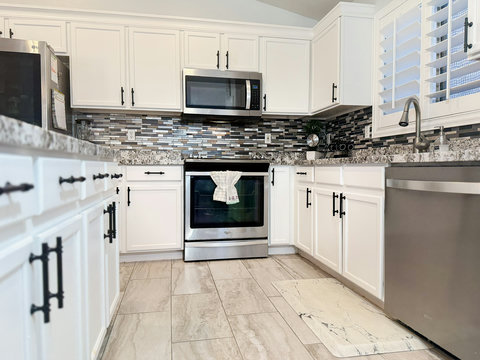 Bright modern kitchen with granite counters and stainless appliances