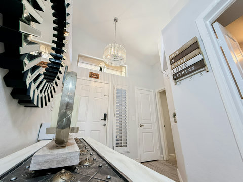 Bright designer entryway with high ceilings and elegant chandelier