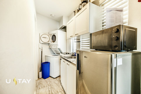 Bright kitchenette with mini fridge, microwave & in-unit washer/dryer