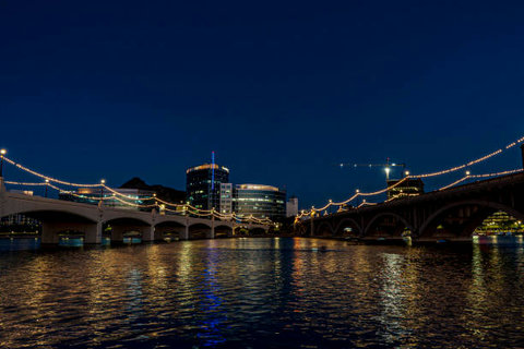 Scenic nighttime river view with glowing bridges and city lights