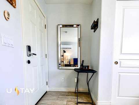 Bright, tidy entryway with mirror and convenient drop zone