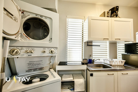 Bright, well-equipped laundry room with washer/dryer and utility sink