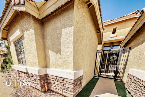 Private gated courtyard entry with stylish stone-accented exterior