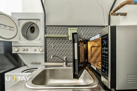 Convenient utility space with in-unit laundry, sink, and microwave