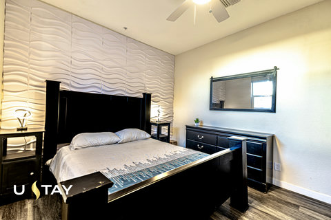 Modern bedroom with statement wall, sleek furnishings, and cozy ambiance