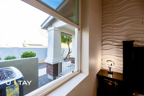 Bright window nook with modern accent wall and entry view