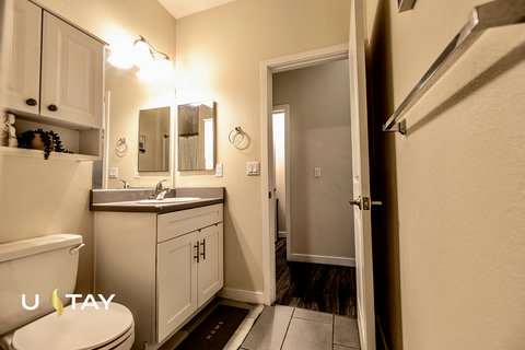 Bright, updated bathroom with modern vanity and convenient storage