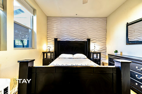Modern bedroom with statement accent wall and natural light