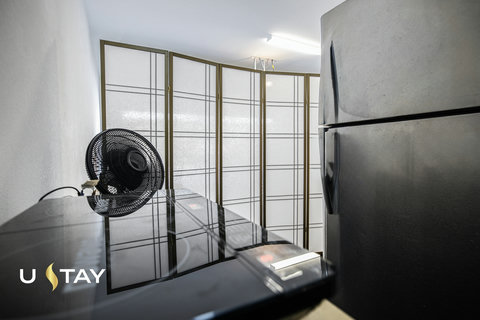 Compact kitchenette with full-size fridge and sleek, modern finishes