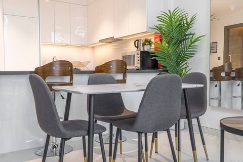 Elegant dining area featuring a marble table and plush chairs.