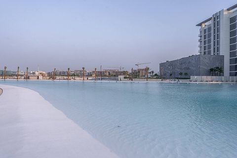 Crystal-clear waters shimmer under the warm sun, inviting you to take a refreshing plunge in this stunning pool.