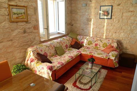 Living room, with big pull-out sofa for 2, traditional walls and modern flat TV.