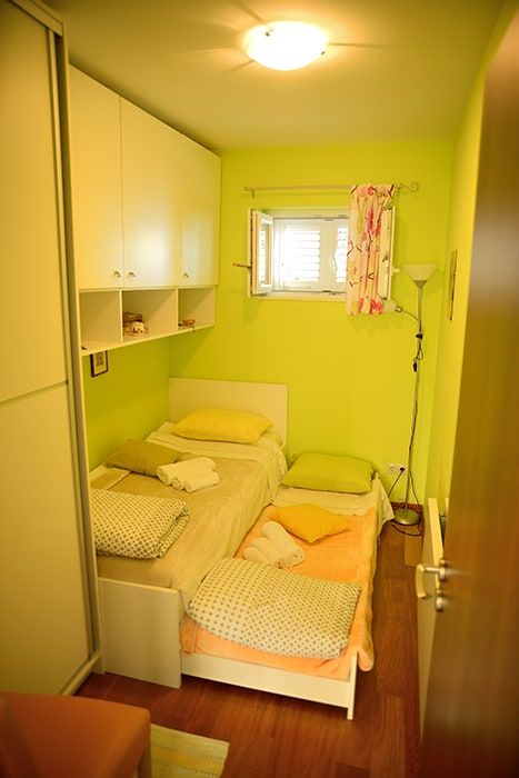 Smaller room with two regular size beds and two big cabinets, looking east.