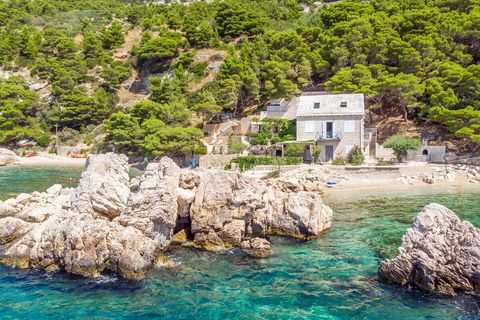 Stunning view of the villa from the sea, framed by crystal-clear waters and the serene coastline.