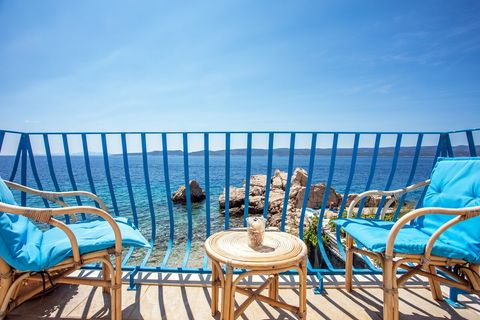 Relax on the balcony with panoramic views of the sparkling sea, perfect for peaceful mornings or sunset moments.