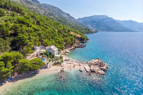 Aerial shot highlighting the villa’s architecture and its breathtaking seaside location.