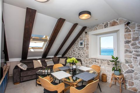 Seamless living and dining area overlooking the sea, ideal for preparing meals and spending time with loved ones.