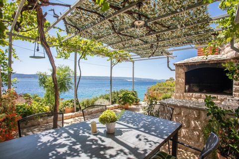 Dine al fresco with stunning sea views, complemented by a beautiful outdoor kitchen for effortless entertaining.