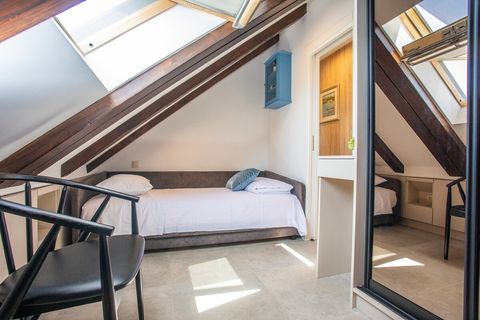 Warm and inviting bedroom with two single beds, perfect for children or friends to rest comfortably.