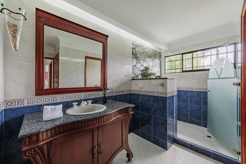 Bathroom of the main bedroom with independent toilet area and natural gardening in the shower.