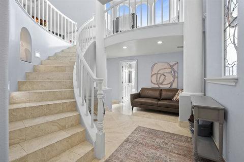 Stairway from Ground Floor to Second Floor Ascend this elegant staircase, where natural light pours in and leads you to the heart of the home – the living and dining spaces.
