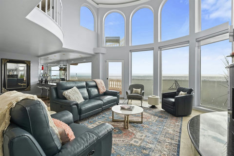 Spectacular Ocean View Living Room Gather in the stunning living room, where floor-to-ceiling windows frame breathtaking ocean views. Sink into plush blue leather reclining chairs as the sound of waves becomes your soundtrack. Walk-through youtu.be/g