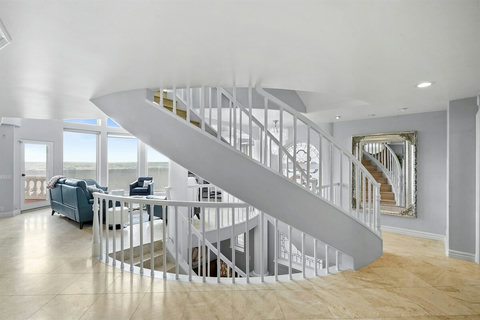 Staircase to Third Floor This elegant staircase leads to private retreats and the stunning rooftop deck.