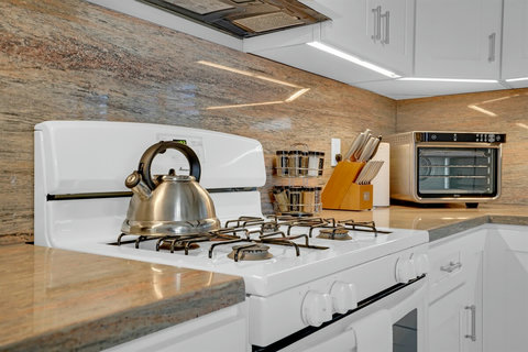 Chic kitchen with new stainless appliances—fully stocked and ready for anything from beach snacks to seafood feasts.