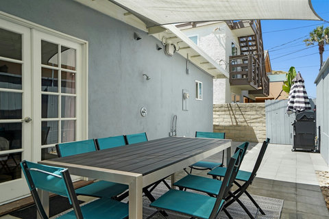 Enjoy dinner outdoors on the private rear patio with a dining set and BBQ grill—perfect after a day in the sun.