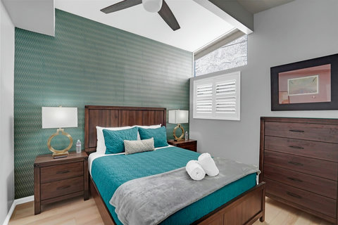 Queen bedroom with fresh linens, natural light, and a relaxing beachy vibe.