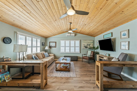A step up leads to the living room with a comfy sleeper sofa and a 65" Smart TV—great for movies and relaxing nights in.