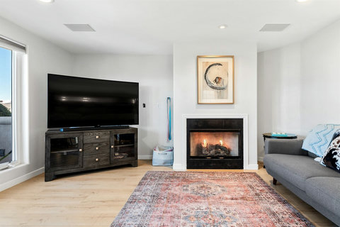 Living room features Roku TV and a fireplace – unwind in comfort
