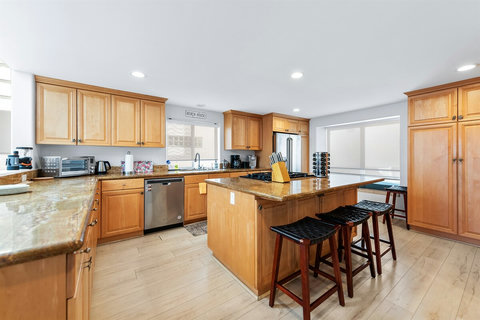 Modern kitchen with top-tier appliances, a spice rack, and everything you need for home-cooked meals