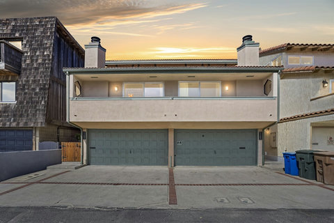 Exterior: Modern beach retreat with spacious parking and stunning sunset views!