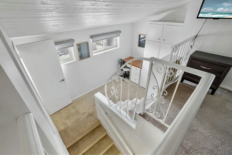 Ascend to your cozy loft, where a queen bed beckons for a restful night's sleep. With a smart TV at your fingertips, unwind in comfort and style in this elevated retreat.