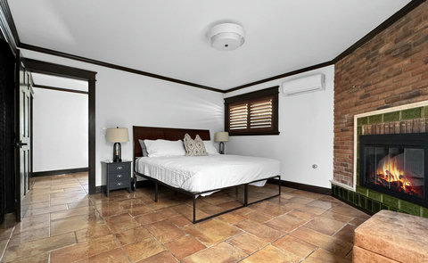 King bedroom with ensuite bathroom and fireplace
