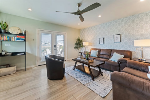 Cozy Living Room with Ocean Breeze Kick back and relax in the living room, where coastal comfort meets casual style. Let the ocean breeze flow in from the nearby balcony.