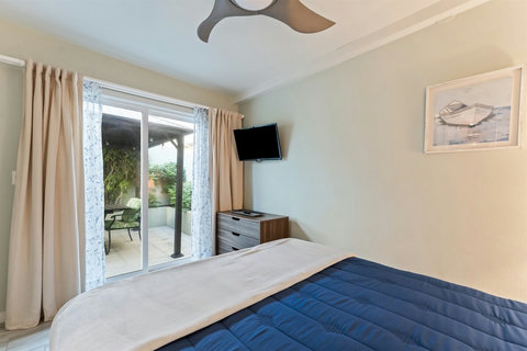 Garden View Queen Bedroom Sleep peacefully in a queen bed with views of the backyard garden and easy ensuite access.