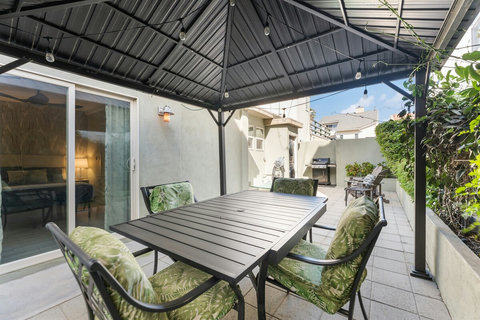 Fenced Backyard with Dining, BBQ & Laundry Access This fully fenced backyard has everything you need: outdoor dining under the lights, a BBQ for grilling, and laundry access—all in a secure, private space.