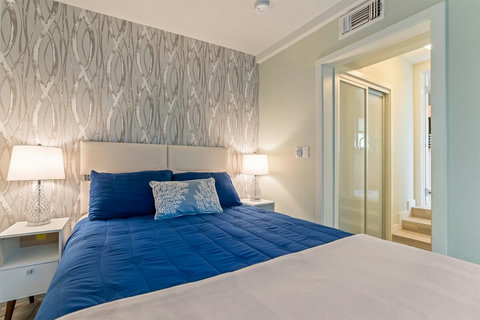 Garden View Queen Bedroom Sleep peacefully in a queen bed with views of the backyard garden and easy ensuite access.