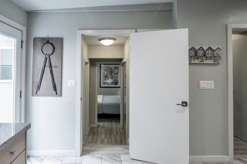 Hallway to Garden View Bedroom & Ensuite This quiet hallway leads to a private bedroom retreat with a garden view and full ensuite bath.